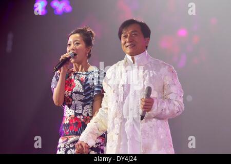 Beijing, China. 6th Apr, 2014. Action movie actor Jackie Chan (R) and South Korean actress Kim Hee Seon sing at a charity concert marking Jackie Chan's 60th birthday in Beijing, capital of China, April 6, 2014. Credit:  Xinhua/Alamy Live News Stock Photo