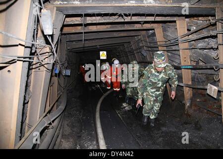 Qujing, China's Yunnan Province. 7th Apr, 2014. Rescuers search for trapped workers at the flooded Xiahaizi coal mine in Dongshan Town of Qujing City, southwest China's Yunnan Province, April 7, 2014. Twenty-two out of the 26 workers have been trapped by the flood happening early Monday. © Ren Jun/Xinhua/Alamy Live News Stock Photo