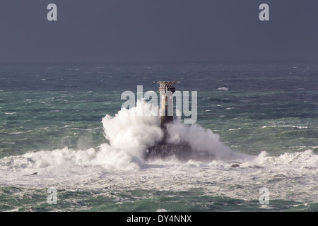 Huge waves crashing Longships Lighthouse photographed from Lands End Cornwall England UK Stock Photo