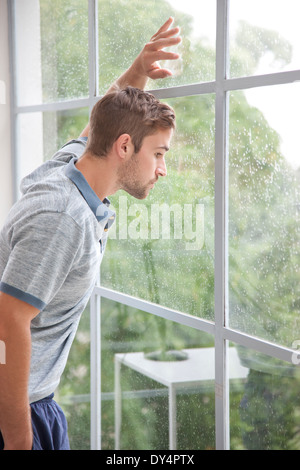 Man Looking out of Window