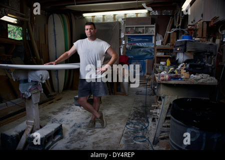 Portrait of mature man in his surfboard workshop Stock Photo