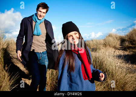 Couple strolling in sand dunes, Bournemouth, Dorset, UK Stock Photo