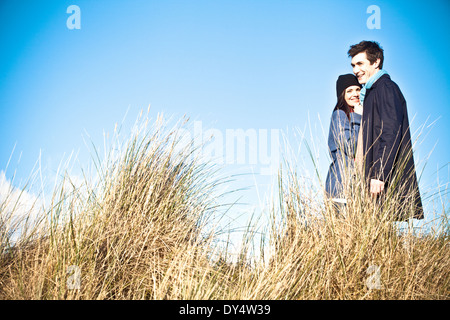 Couple standing in sand dunes, Bournemouth, Dorset, UK Stock Photo