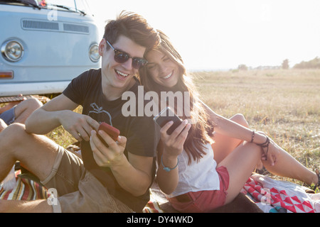 Young couple looking at smartphones Stock Photo