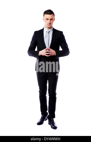 Full length portrait of a guy in a black suit holding his a fedora hat ...