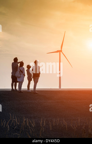 Family group looking at Wind turbines and Eastern Scheldt Storm Surge Barrier designed to protect the Netherlands from Stock Photo