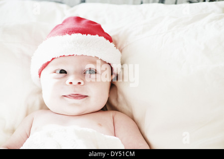 Portrait of smiling baby boy in santa hat Stock Photo