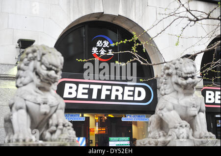 Gerrard Street, London, UK. 7th April 2014. A Betfred betting shop with the Lions statues in Chinatown. Credit:  Matthew Chattle/Alamy Live News Stock Photo