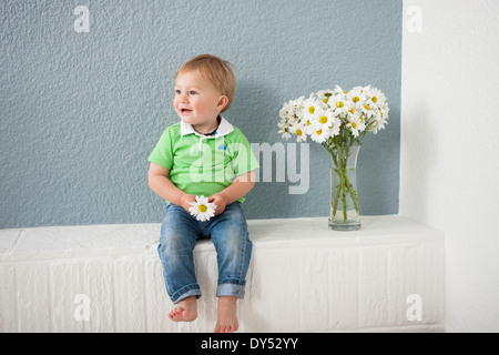 Baby boy playing with flowers Stock Photo