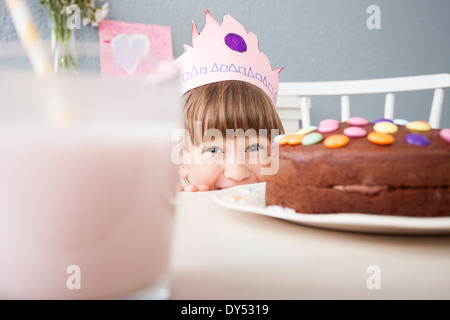 Girl hiding behind cake Stock Photo