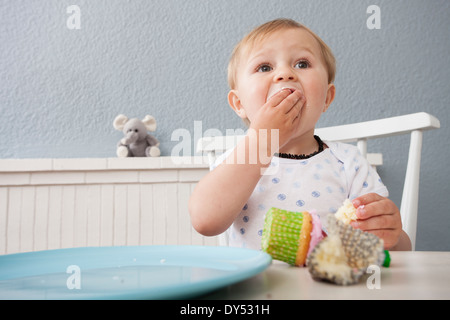 Baby boy eating cupcake Stock Photo
