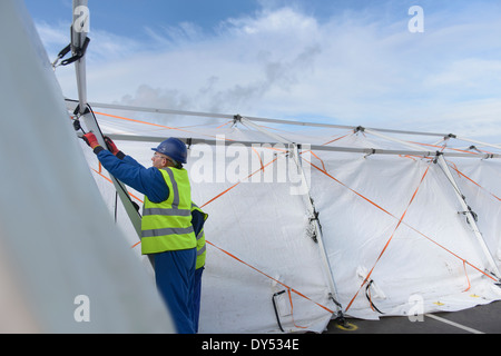 Emergency Response Team workers erecting tent control centre