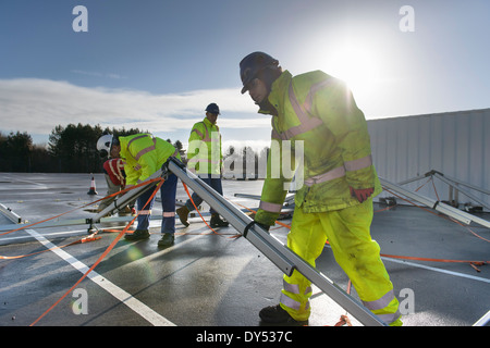 Emergency Response Team workers erecting tent control centre