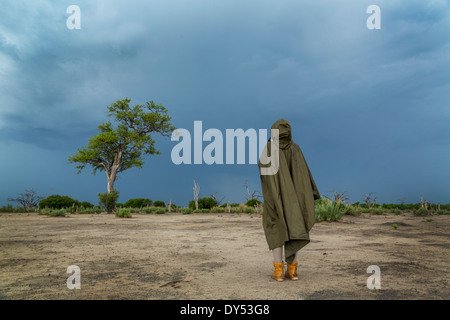 Woman photographing storm clouds, Kasane, Chobe National Park, Botswana, Africa Stock Photo