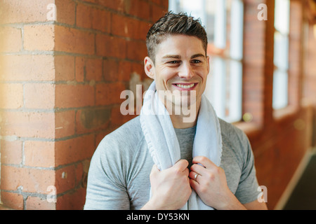 Man in gym with towel around neck Stock Photo