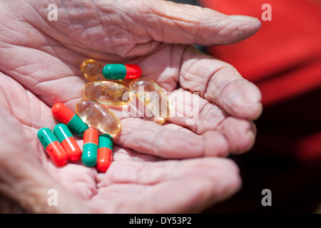 Close up of senior woman's hands holding pills Stock Photo