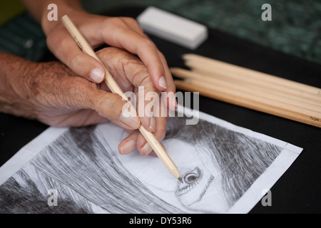 Close up of senior woman's hand doing a pencil drawing Stock Photo