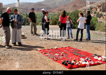 Roadside viewpoint by village of Tahnaout (on R203 road out of Marrakech) with men offering souvenirs to tourists, Morocco Stock Photo