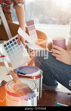 Two teenage sisters with coffee and color swatches Stock Photo