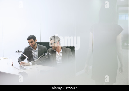 Male business colleagues using digital tablet in office Stock Photo
