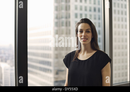 Portrait of businesswoman in high rise office Stock Photo