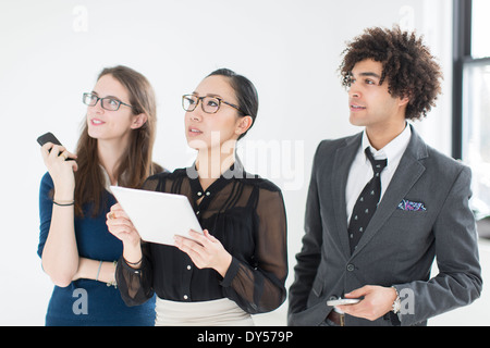 Three colleagues using digital tablet Stock Photo