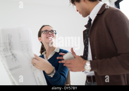 Two colleagues discussing blueprint Stock Photo