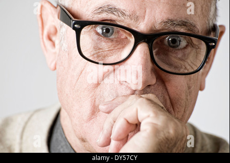 Portrait of senior man, hand on mouth Stock Photo