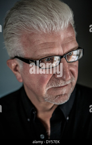 Close up of thoughtful senior man wearing spectacles Stock Photo