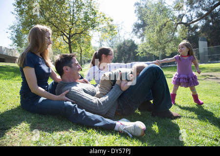 Happy family relaxing on grass