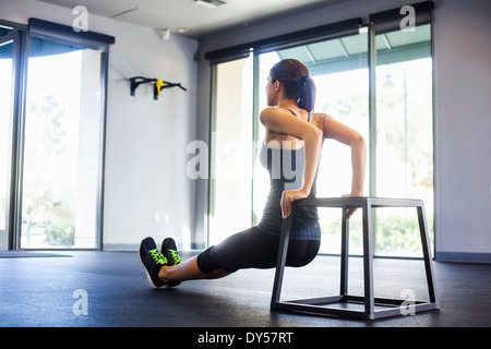 Young woman doing push ups Stock Photo