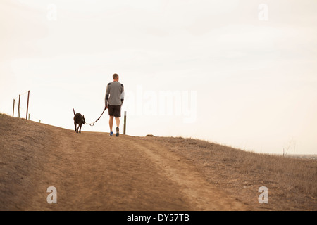 Man walking dog Stock Photo