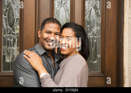 Portrait of happy mid adult couple at front door Stock Photo