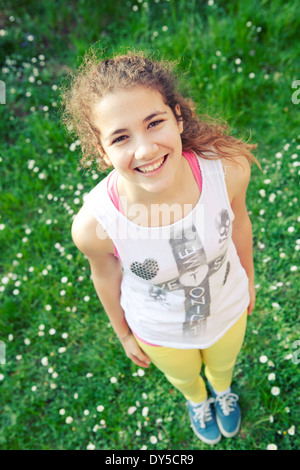 High angle portrait of a young girl smiling in the garden Stock Photo
