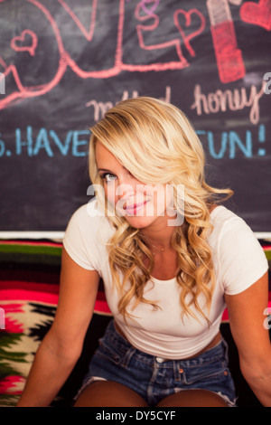 Young woman with blonde hair, smiling Stock Photo