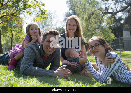 Happy family relaxing on grass Stock Photo