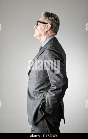 Portrait of senior man, wearing suit, side view