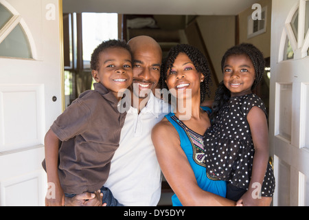 Portrait of mature couple with son and daughter at front door Stock Photo