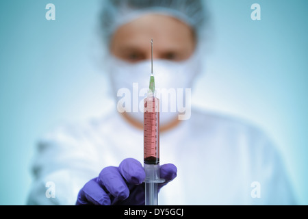 Doctor holding syringe Stock Photo