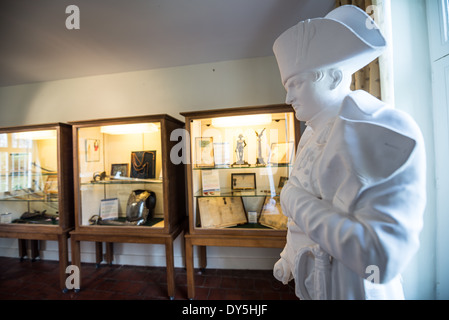 Napoleon Bust Ferme du Caillou Waterloo Belgium | VIEUX-GENAPPE, Belgium — An official imperial bust of Napoleon Bonaparte overlooks display cases of military artifacts in the Hussar's Room at Ferme du Caillou. Busts of this standardized design were distributed across the French Empire to project the emperor's authority. The farmhouse behind the collection served as Napoleon's final headquarters before his defeat at Waterloo, and is now the only Napoleonic museum in Belgium. Stock Photo