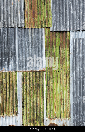 Rusty weathered metal sheeting layers on barn exterior Stock Photo