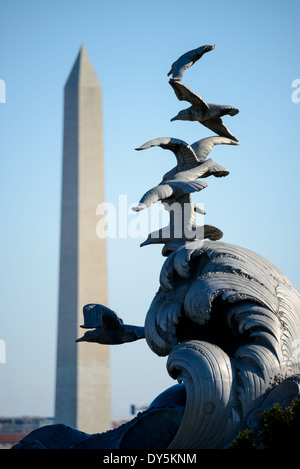 The Navy-Merchant Marine Memorial, located in Lady Bird Johnson Park on Columbia Island in Washington, D.C., is a monument honoring sailors of the United States Navy and the United States Merchant Marine who died at sea during World War I. It was designed in 1922 by Harvey Wiley Corbett and sculpted by Ernesto Begni del Piatta. It was dedicated on October 18, 1934. In the background is the Washington Monument. Stock Photo