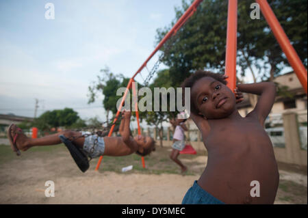 RIO DE JANEIRO, BRAZIL - APRIL 7: Children playing in a small park in the slum Mac Laren in Complexo da Maré recently occupied by the army, even with the occupation, residents still suffer from the oppression of traffickers, which prohibits residents talk to the army and the press. (Photo by Fabio Teixeira/Pacific Press) Stock Photo