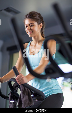 Young woman on cross-trainer