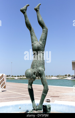 Statue of a pearl diver outside the Bahrain National Museum with the ...