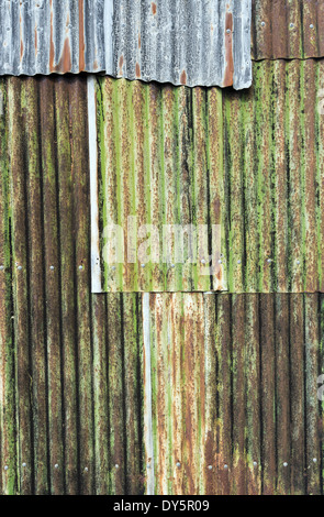 Rusty weathered metal sheeting layers on barn exterior Stock Photo