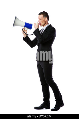 Full length portrait of businessman yelling through megaphone isolated on white background Stock Photo