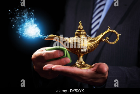 Rubbing magic Aladdins genie lamp Stock Photo