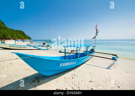 Outrigger boats on beautiful white sand beach in the national park on the south coast at Pangandaran, West Java, Java, Indonesia Stock Photo