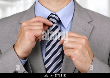 Businessman fixing his tie Stock Photo